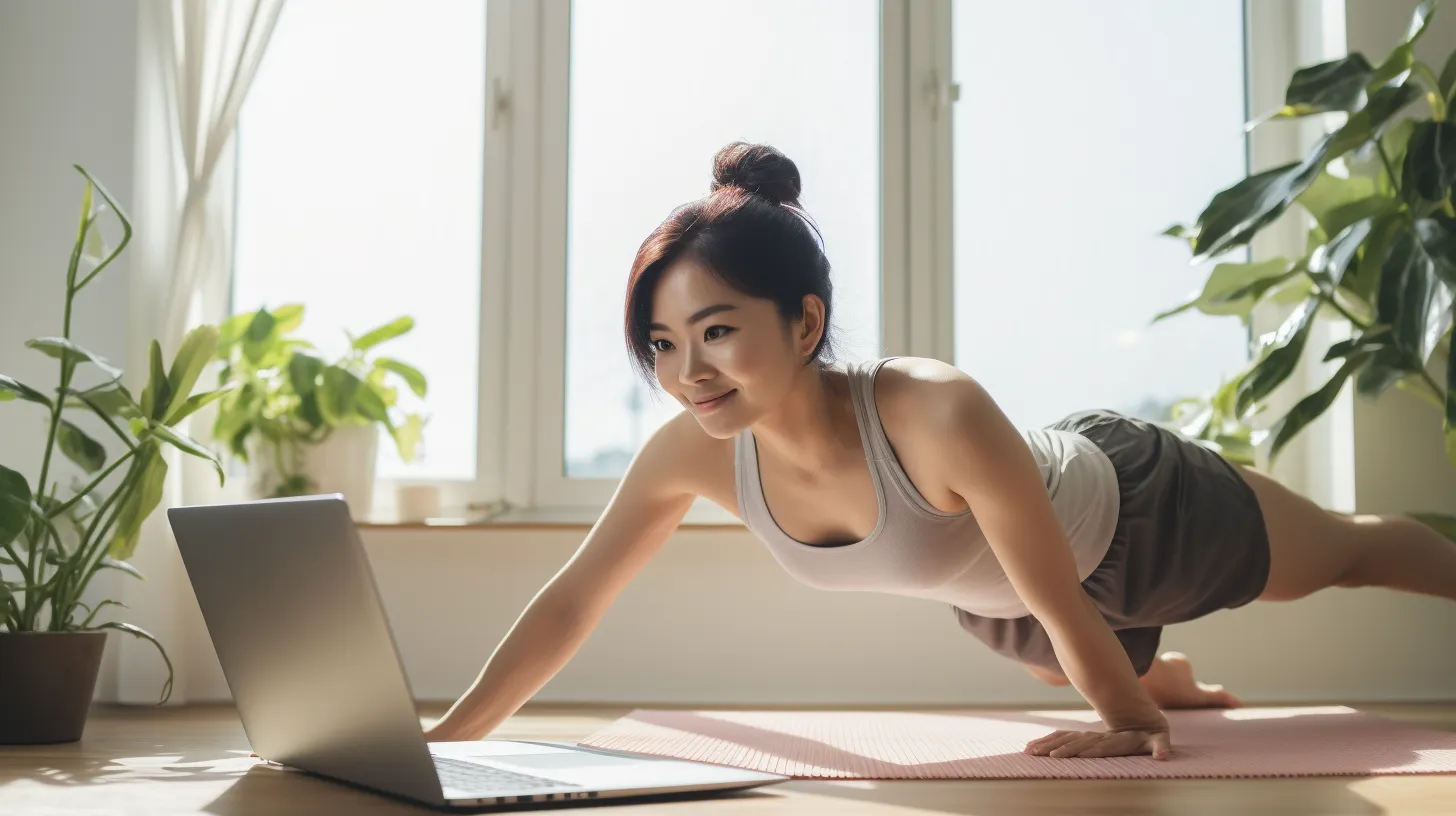 An asian girl performing a press exercise as she watches the routine from her laptop